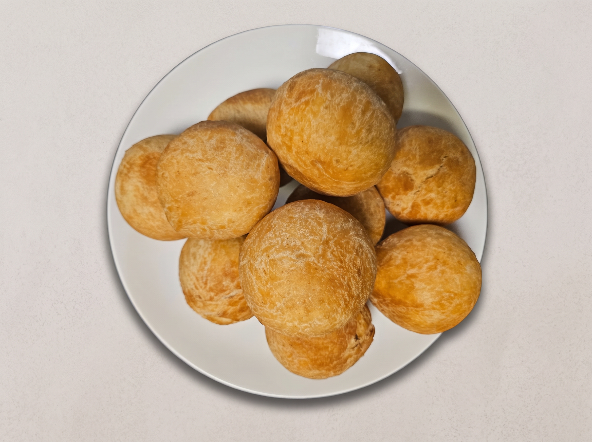 Fresh golden puff puff piled on a plate